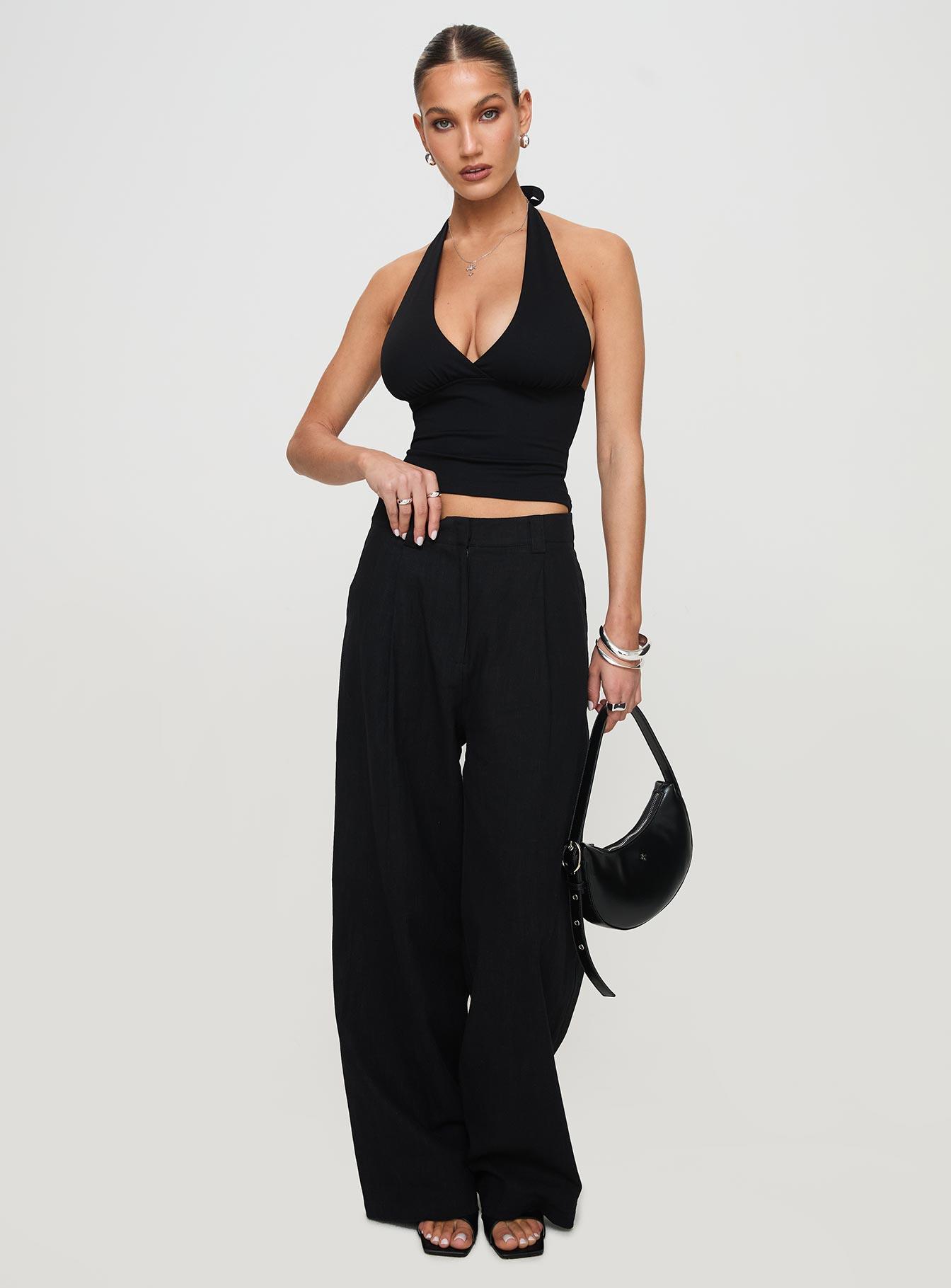 side view of model wearing Princess Polly Whimsy Halter Top Black Sleeveless Plunger 
