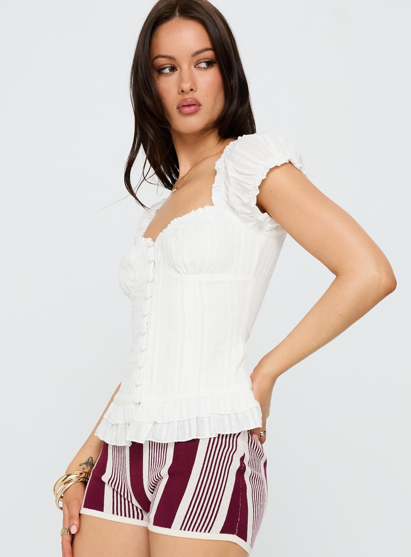 side view of model wearing Princess Polly Suiter Frill Detail Top White Short Sleeves Sweetheart