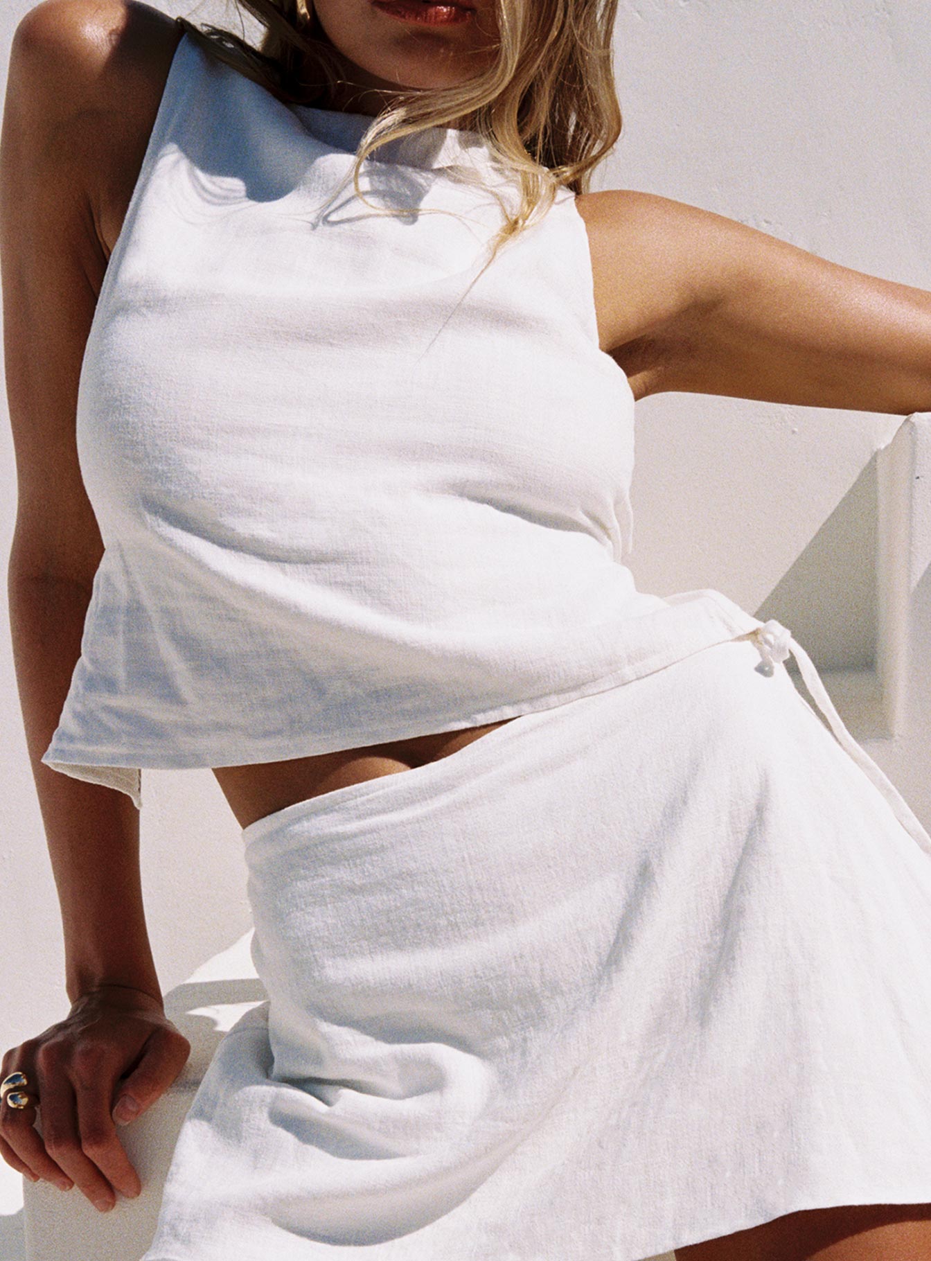 side view of model wearing Princess Polly Penelopie Backless Top White Sleeveless High Neck