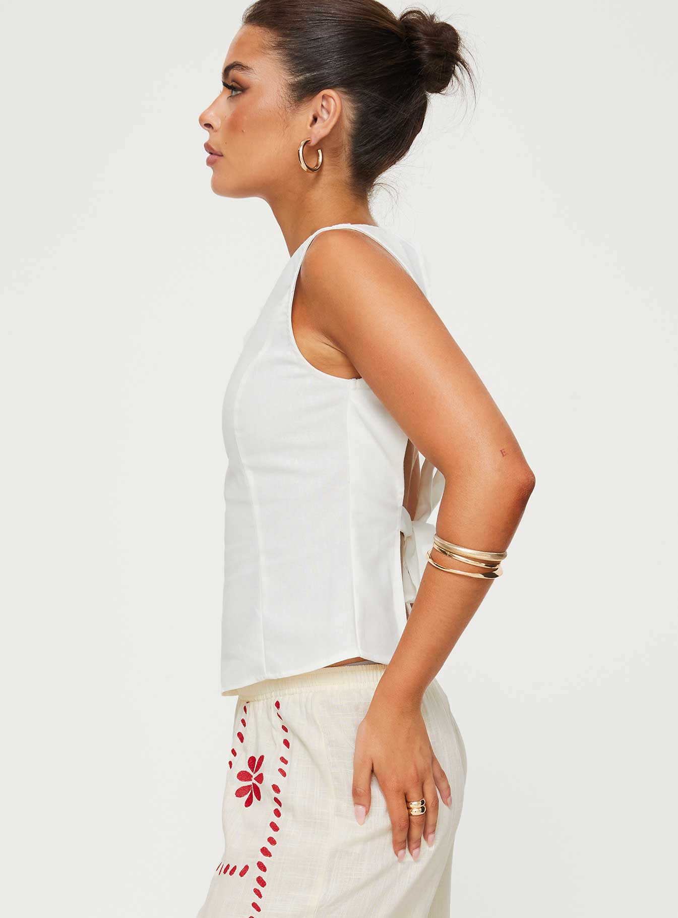 side view of model wearing Princess Polly Lilitina Top White Sleeveless High Neck