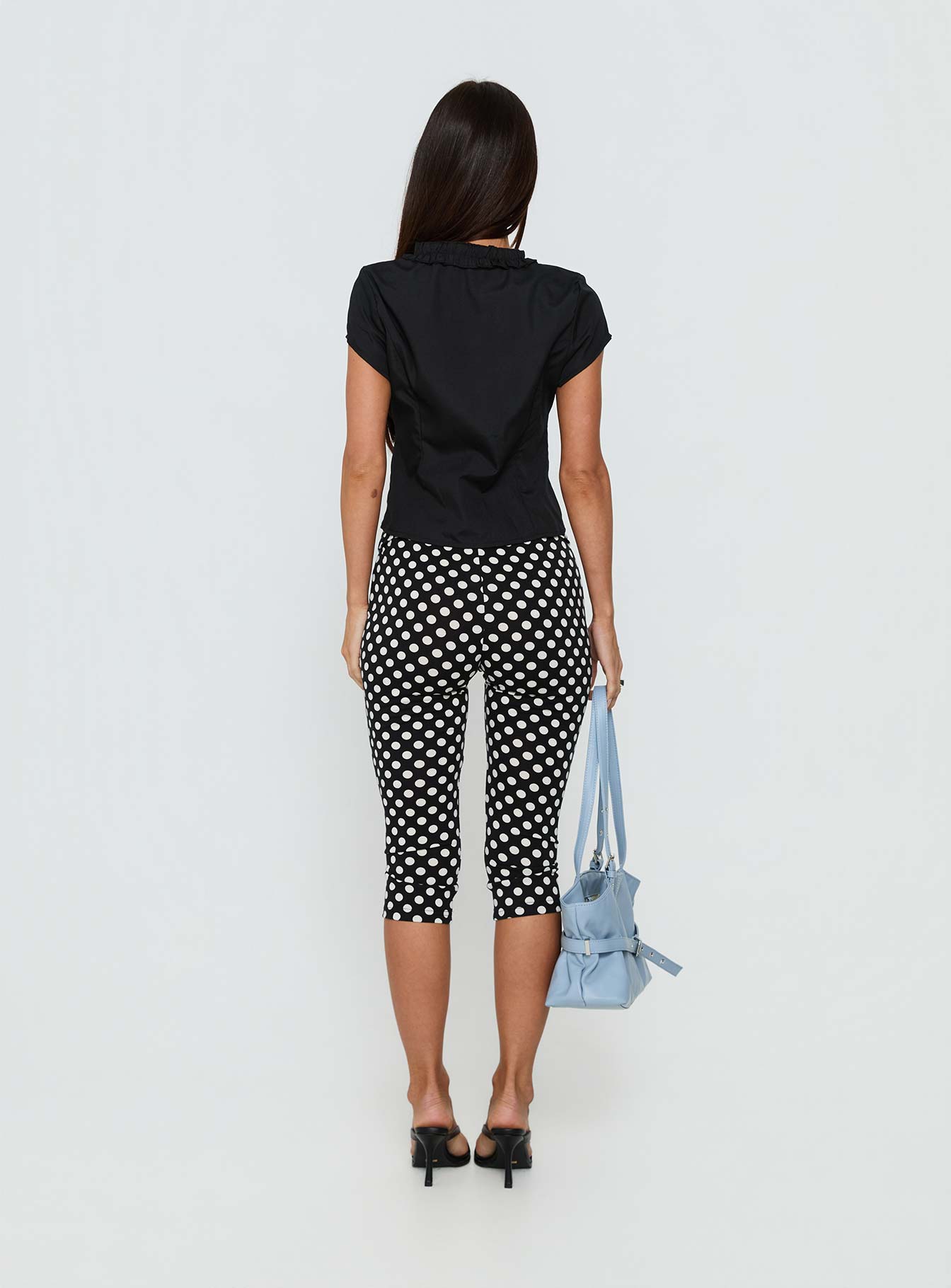 back view of model wearing Princess Polly Isadonna Capri Pants Black Polka Dot Mid Rise Pants 
