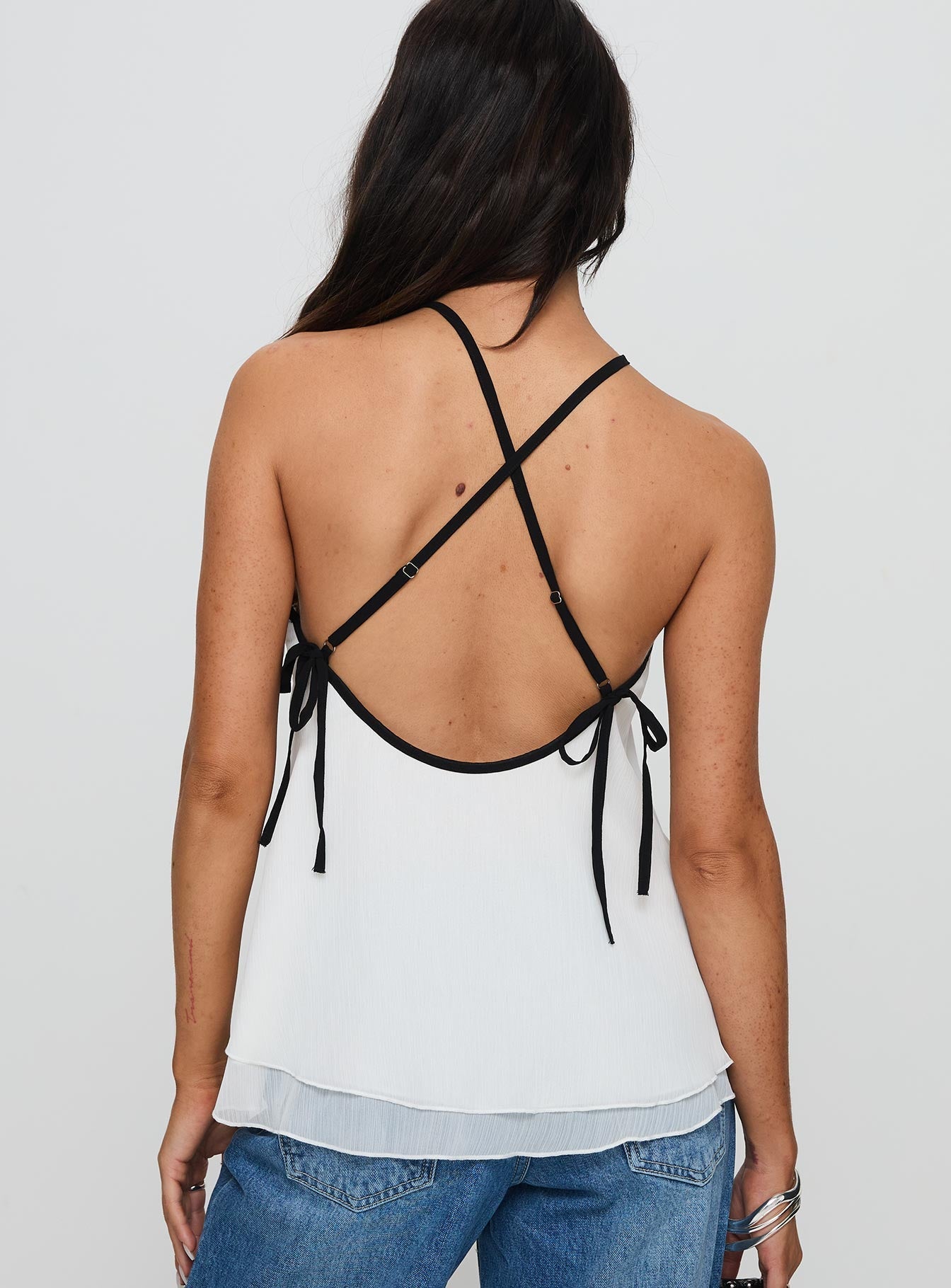 back view of model wearing Princess Polly Rafaella Halter Top Cream Sleeveless Asymmetric Neckline