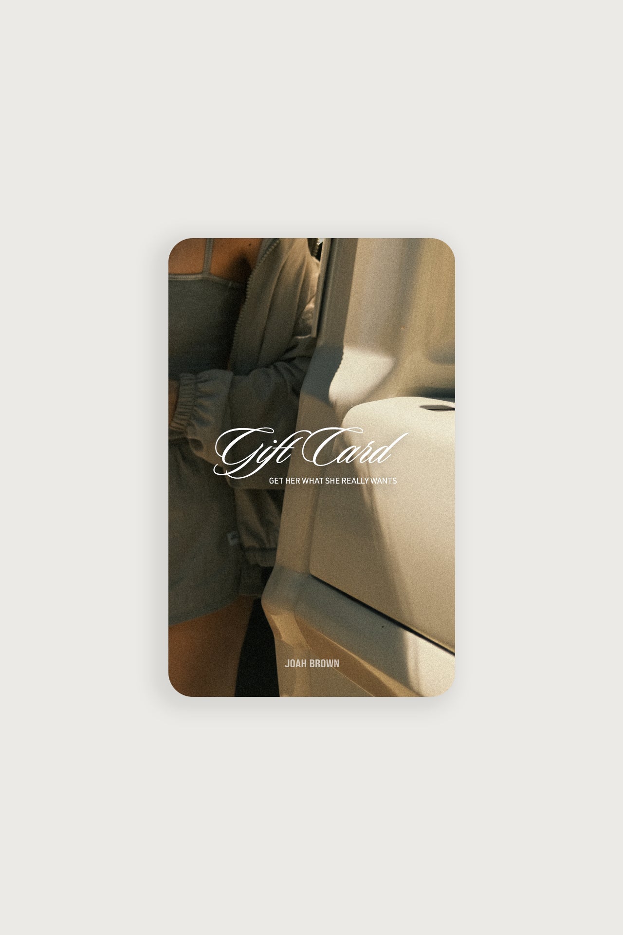 Front view of the JOAH BROWN gift card featuring the text:  -Gift Card. Get her what she really wants- over a model getting out of a car
