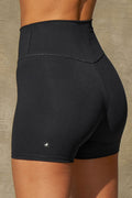 Close up detail back view of model from the waist down posing the soft and stretchy high-waisted sueded onyx 2.5 inch Body Short with a wide waistband and shortened 2.5 inch inseam