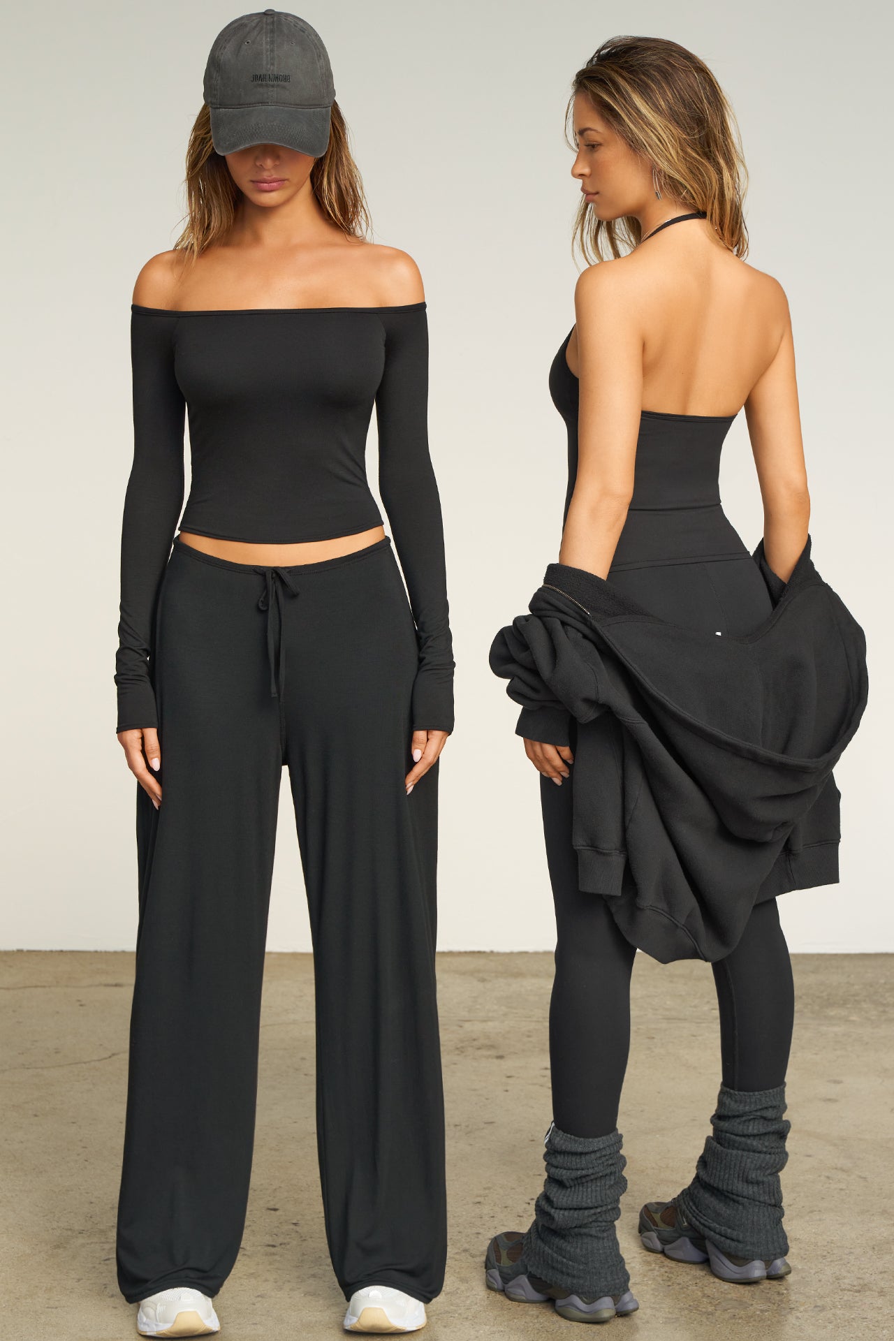 Two models posing in black Joah Brown tops and bottoms