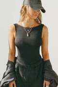 Front view of model posing in the fitted, lightweight black modal Boatneck Tank top with a boat neckline