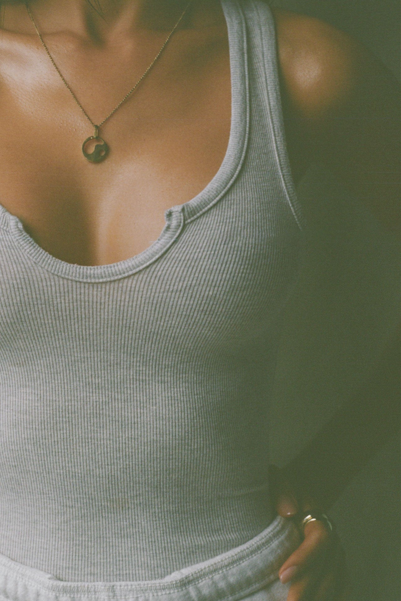 Close up detail front view of model posing in the fitted, full length pearl grey flexrib Henley Tank with a notched henley neckline