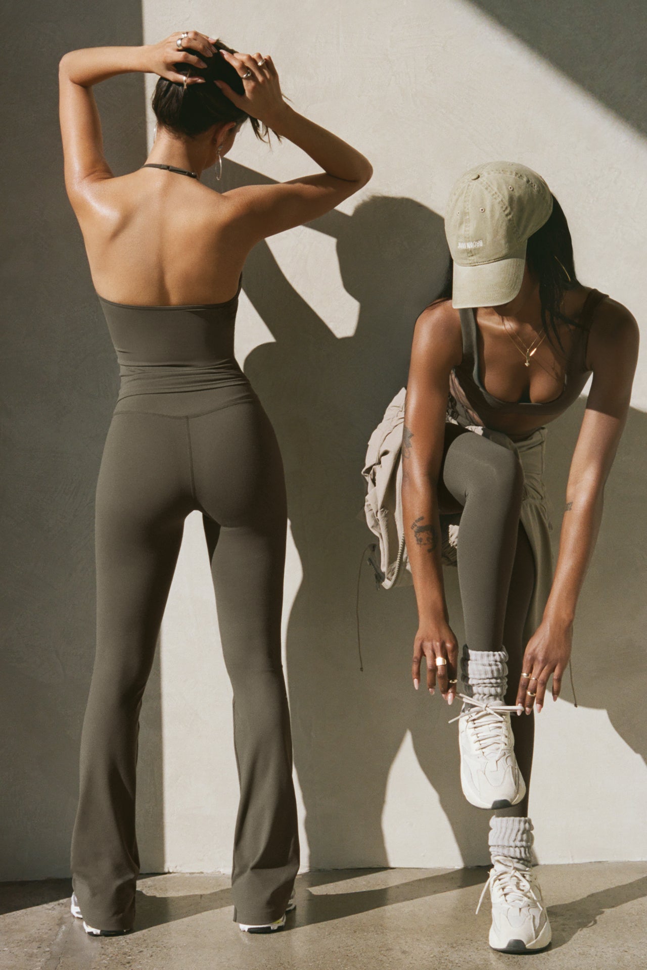 Two models posing in sueded carob top and legging sets