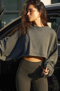 Front view of model posing in the cropped relaxed fit haze cotton Slouchy Crop Long Sleeve top with a crew neckline, dropped shoulders and oversized sleeves